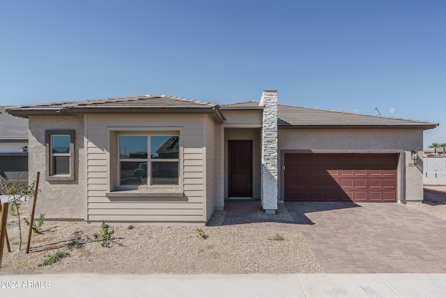 prairie-style home featuring a garage