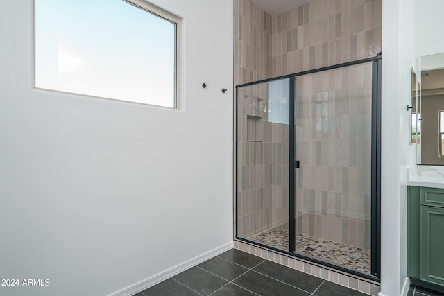 bathroom with tile patterned floors, an enclosed shower, and vanity