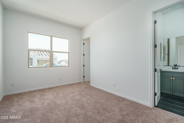 carpeted spare room with sink