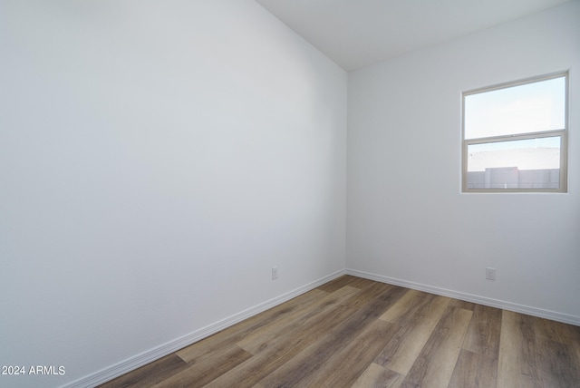 empty room with hardwood / wood-style flooring