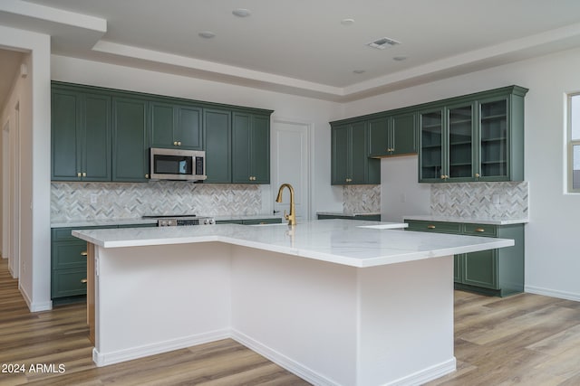 kitchen featuring a spacious island, stainless steel appliances, and light wood-type flooring