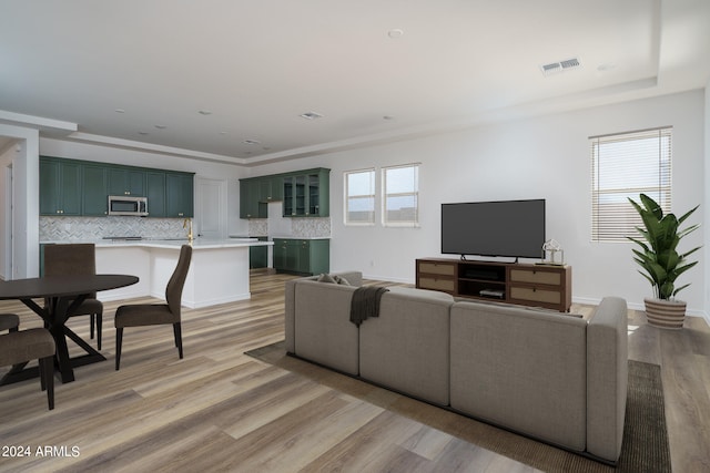 living room with light wood-type flooring and plenty of natural light