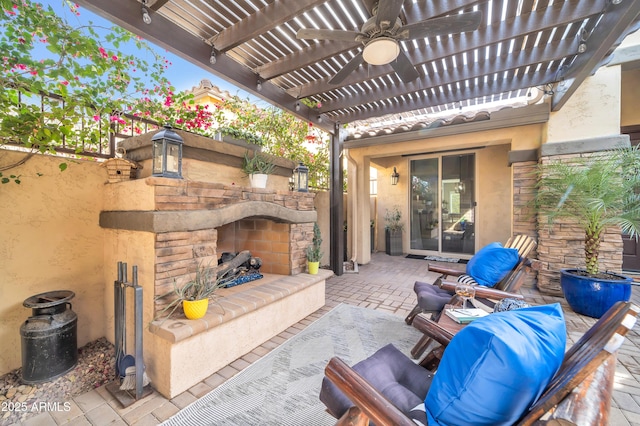 view of patio featuring an outdoor stone fireplace and a pergola