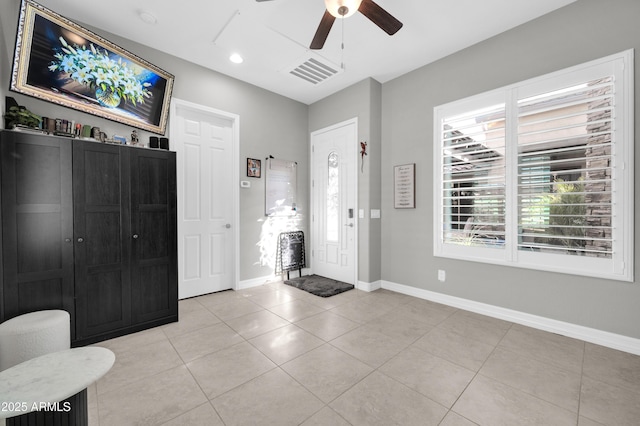 tiled entryway with ceiling fan