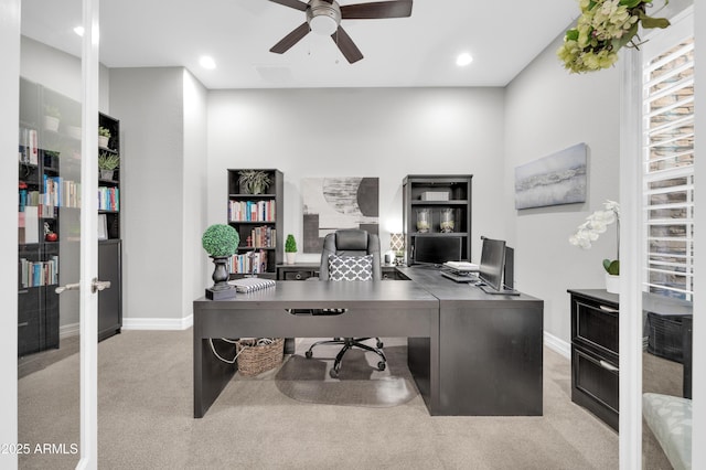 carpeted office featuring ceiling fan