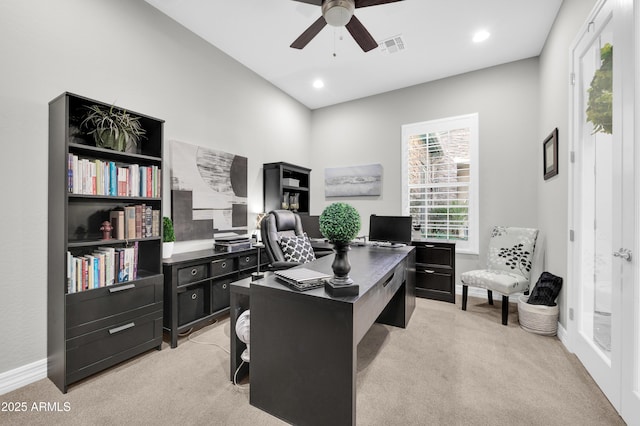 carpeted home office featuring ceiling fan