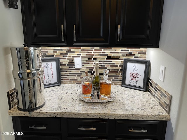 kitchen with tasteful backsplash and light stone countertops