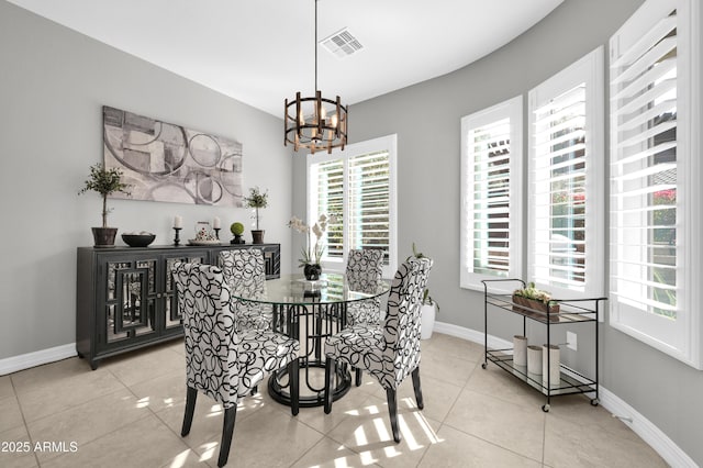 tiled dining area featuring an inviting chandelier