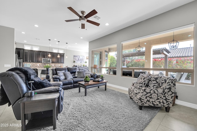 living room with ceiling fan and light tile patterned floors