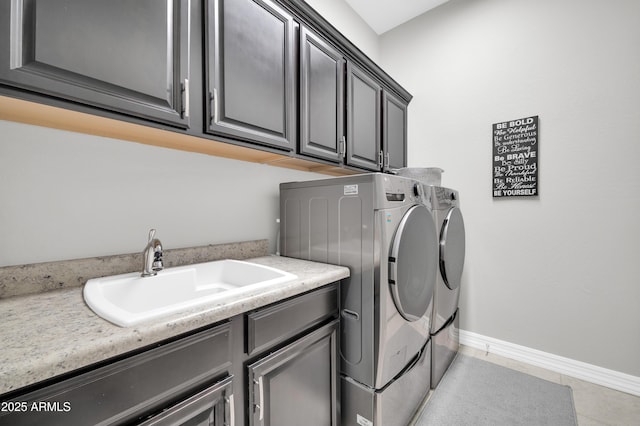 clothes washing area featuring cabinets, separate washer and dryer, sink, and light tile patterned floors