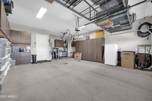 garage with a garage door opener and white fridge