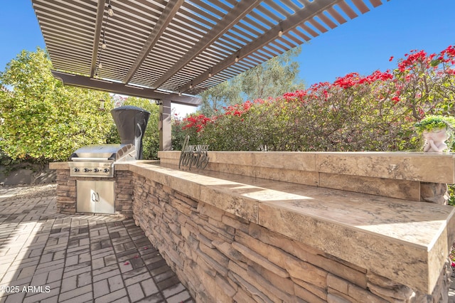 view of patio featuring an outdoor kitchen, grilling area, and a pergola