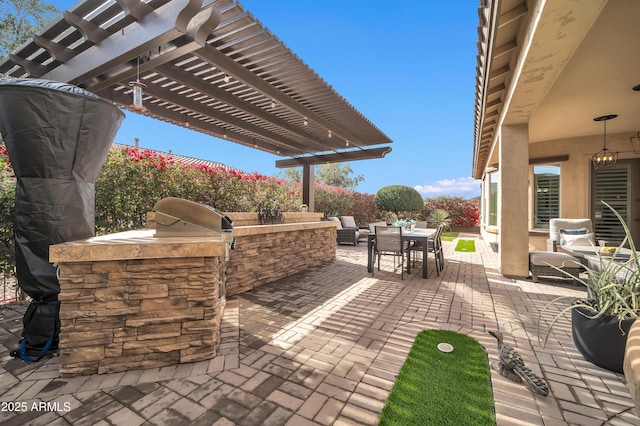 view of patio with an outdoor kitchen and a pergola