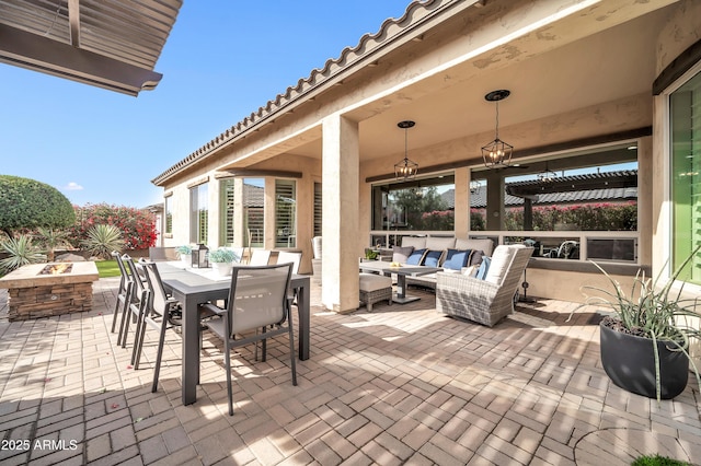 view of patio featuring an outdoor living space with a fire pit and a pergola