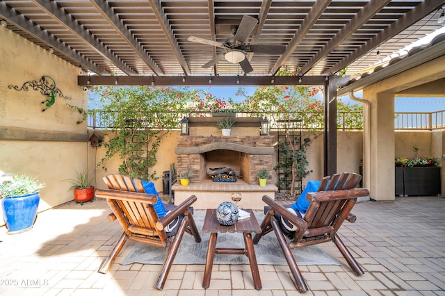 view of patio / terrace with ceiling fan, a pergola, and an outdoor stone fireplace