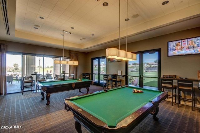 rec room featuring dark colored carpet, billiards, and a tray ceiling