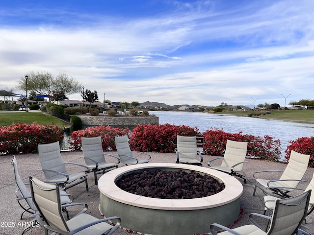 view of patio with a water view and a fire pit