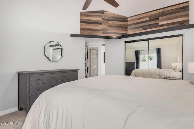 bedroom featuring baseboards, carpet floors, a closet, ceiling fan, and vaulted ceiling