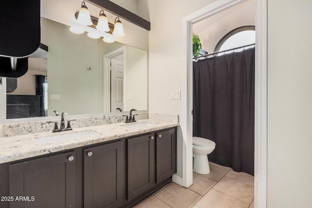 full bath featuring tile patterned floors, toilet, and double vanity