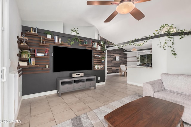tiled living area featuring vaulted ceiling, ceiling fan, and baseboards