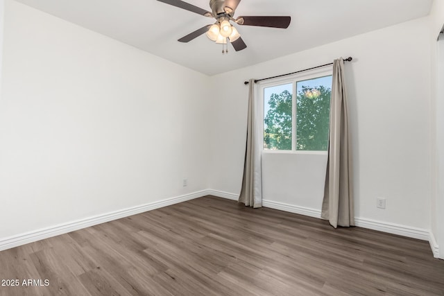 unfurnished room with ceiling fan and dark wood-type flooring