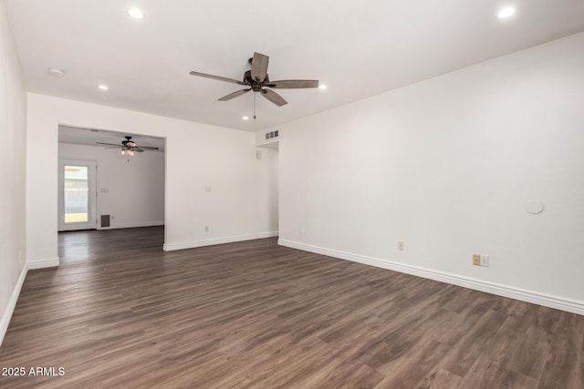 empty room with dark hardwood / wood-style floors and ceiling fan