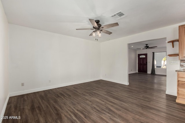 unfurnished living room featuring ceiling fan and dark hardwood / wood-style flooring