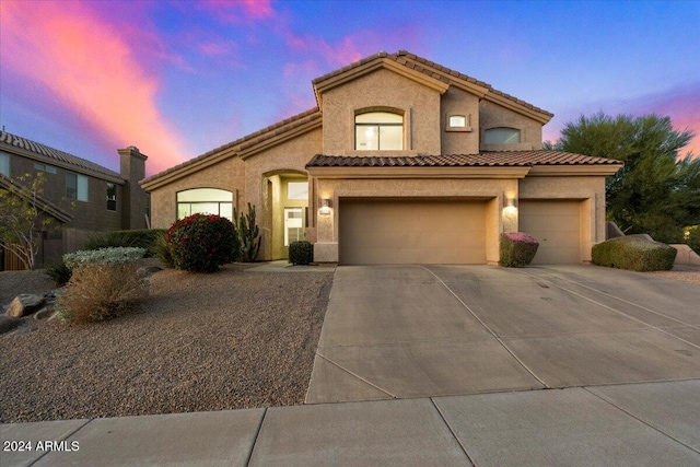 mediterranean / spanish-style house with a garage