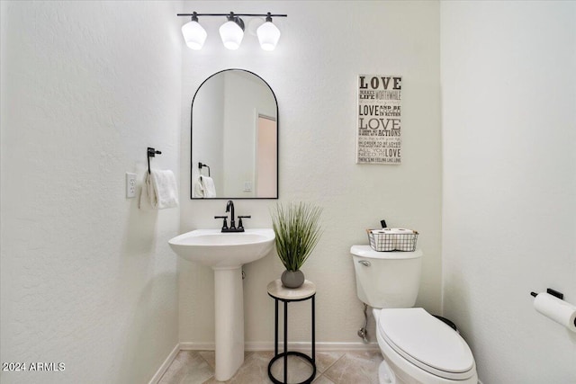 bathroom with tile patterned floors, sink, and toilet