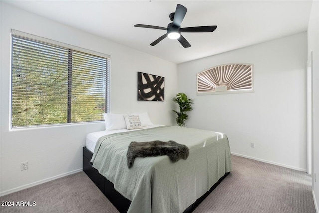 bedroom featuring ceiling fan and light carpet