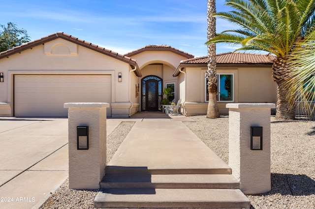 mediterranean / spanish-style home featuring a garage