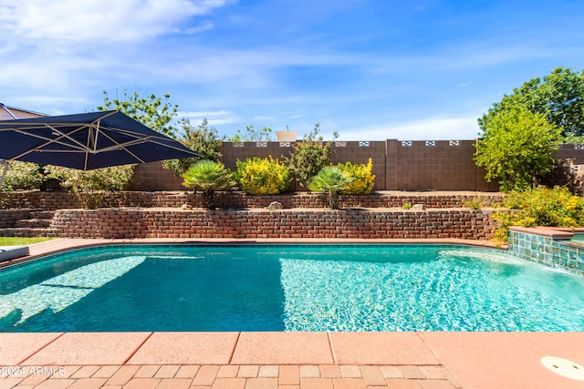 view of swimming pool with pool water feature