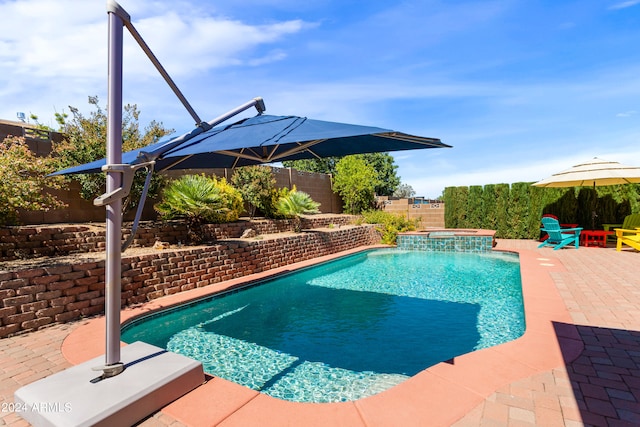 view of pool with an in ground hot tub and a patio area