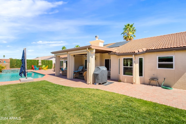 back of property featuring a lawn and a patio area