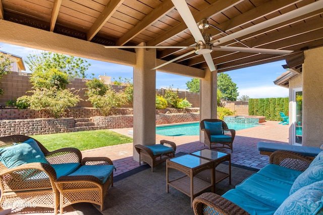 view of patio featuring ceiling fan and a fenced in pool