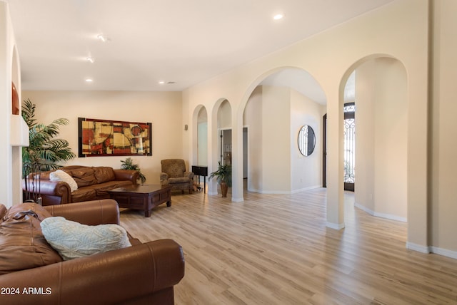 living room with lofted ceiling and light hardwood / wood-style floors