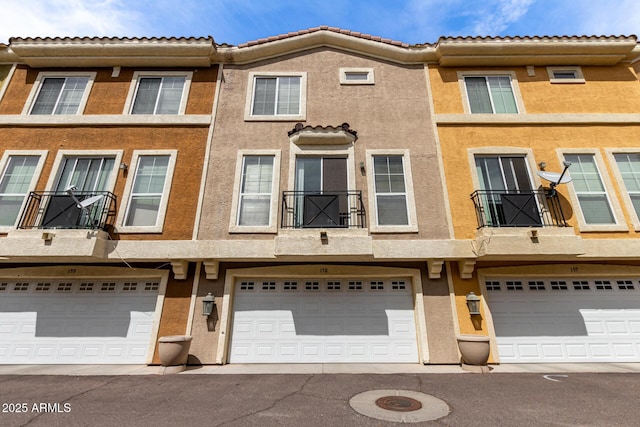 22125 N 29th Ave Unit 158, Phoenix, AZ 85027 - back of house featuring stucco siding, a garage, and a tile roof