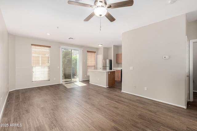22125 N 29th Ave Unit 158, Phoenix, AZ 85027 - unfurnished living room with baseboards, dark wood-style flooring, and ceiling fan