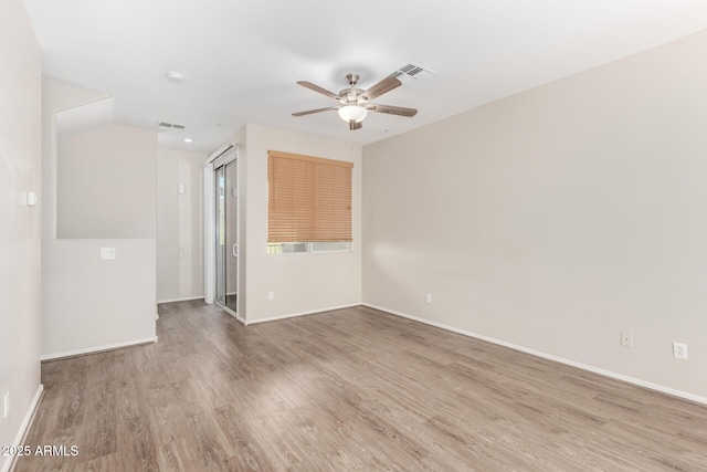 22125 N 29th Ave Unit 158, Phoenix, AZ 85027 - empty room featuring wood finished floors, ceiling fan, baseboards, and a smoke detector