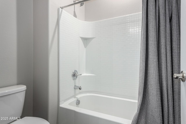 bathroom with toilet and shower / bath combo with shower curtain