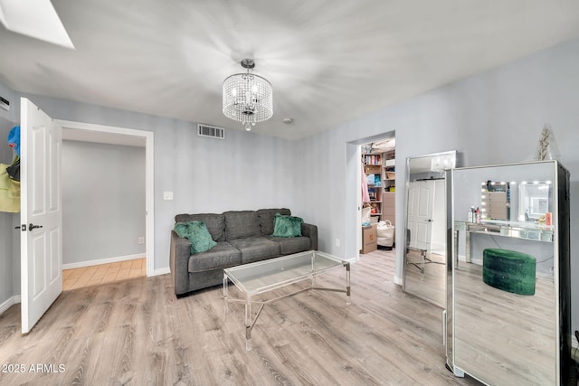 6215 E Surrey Ave, Scottsdale, AZ 85254 - living area featuring wood finished floors and a chandelier
