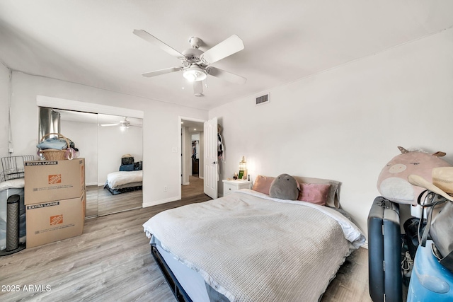 6215 E Surrey Ave, Scottsdale, AZ 85254 - bedroom with wood finished floors, a closet, and a ceiling fan