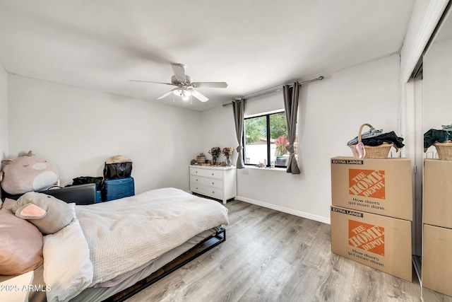 6215 E Surrey Ave, Scottsdale, AZ 85254 - bedroom featuring light wood-type flooring, a closet, and ceiling fan
