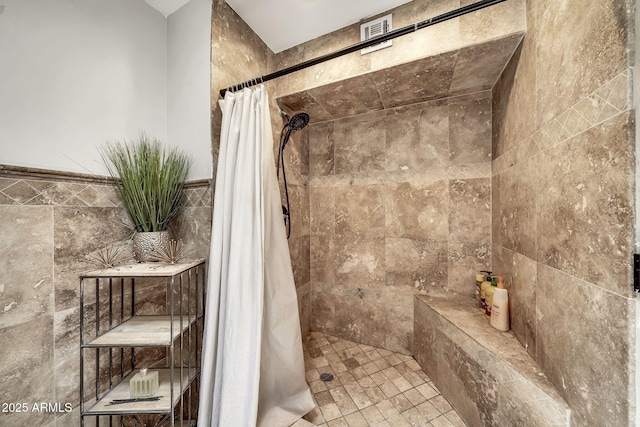 6215 E Surrey Ave, Scottsdale, AZ 85254 - bathroom featuring tiled shower and tile walls