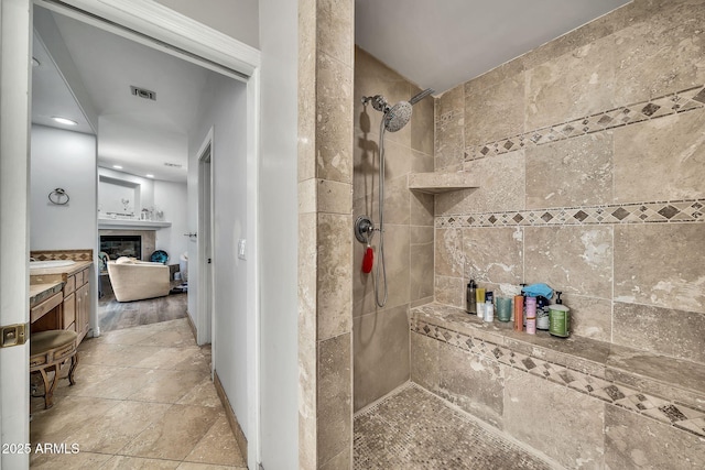 6215 E Surrey Ave, Scottsdale, AZ 85254 - full bathroom with walk in shower, vanity, a glass covered fireplace, and recessed lighting