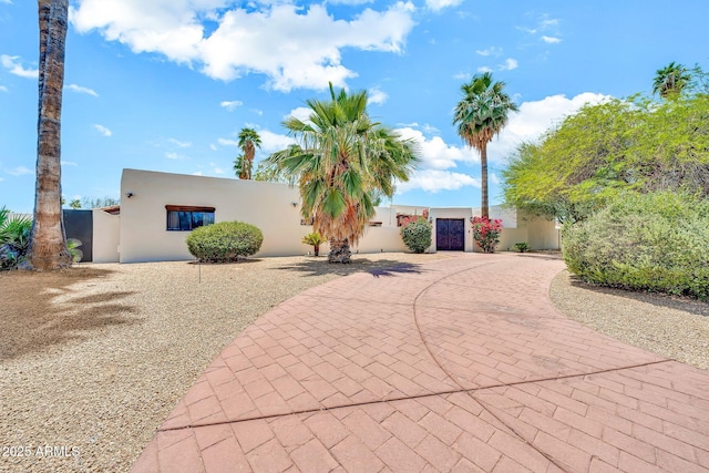 6215 E Surrey Ave, Scottsdale, AZ 85254 - view of front of property featuring curved driveway, stucco siding, and a gate
