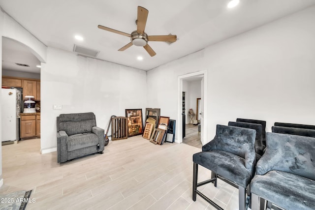 6215 E Surrey Ave, Scottsdale, AZ 85254 - sitting room featuring arched walkways, recessed lighting, ceiling fan, and light wood-style flooring