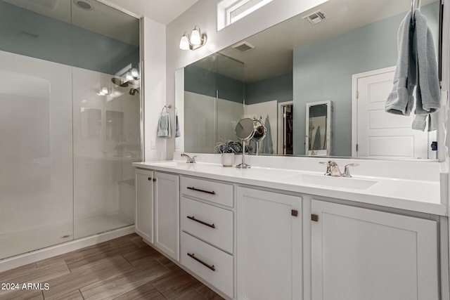 bathroom with vanity and a shower