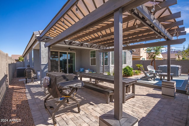 view of patio / terrace featuring central air condition unit, a hot tub, and a pergola