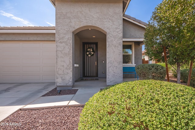 view of exterior entry with a garage